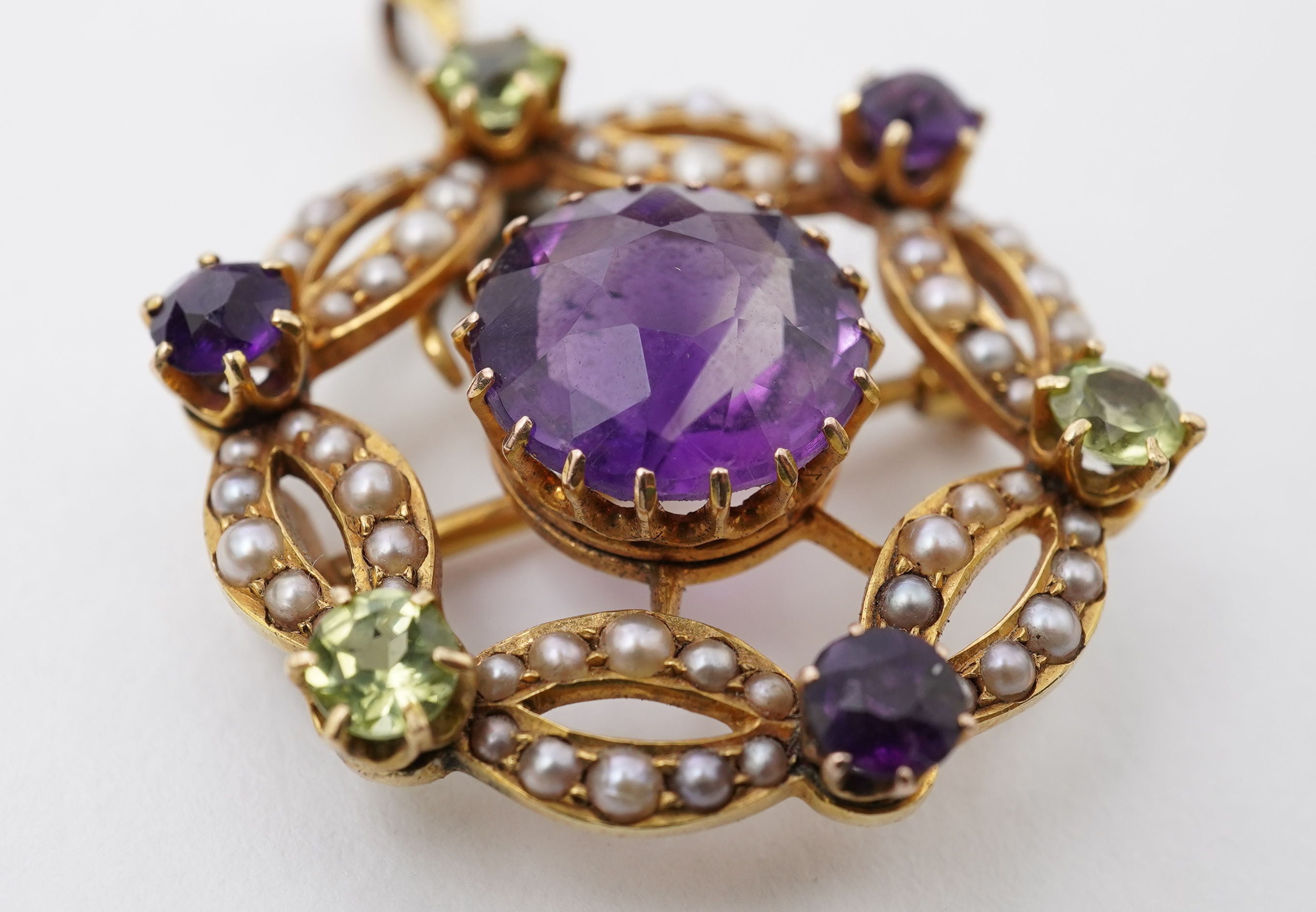 An Edwardian amethyst, chrysoberyl and seed pearl pendant/brooch, early 20th century